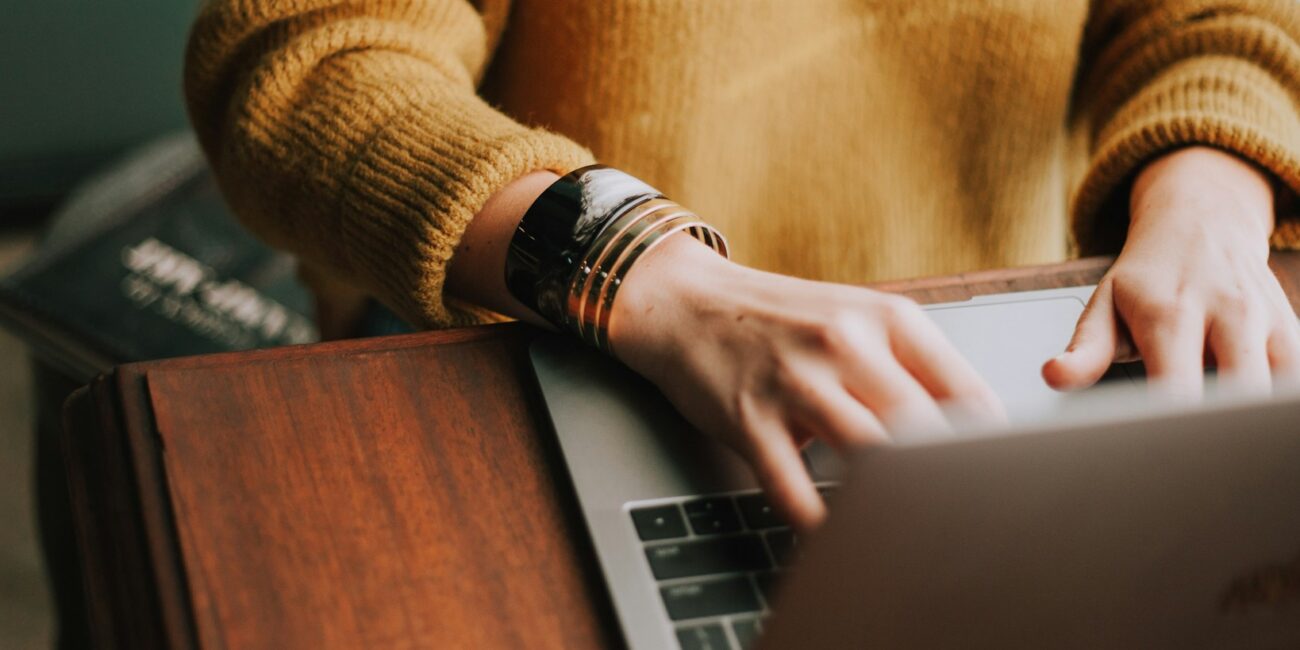 laptop with writing hand